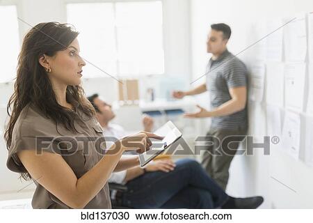 Hispanic businesswoman using tablet computer in office View Large Photo Image Stock Image - Hispanic businesswoman using tablet computer in office. Fotosearch
