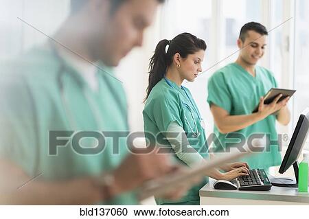 Stock Image - Hispanic nurses working in hospital. Fotosearch