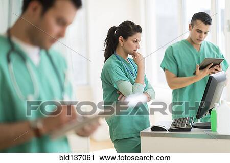 Stock Image - Hispanic nurses working in hospital. Fotosearch