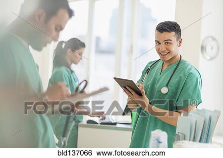 Stock Photograph - Hispanic nurses working in hospital. Fotosearch