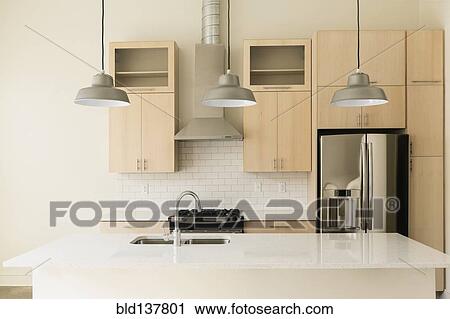 Stock Image - Light fixtures in modern kitchen. Fotosearch