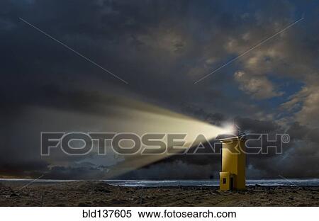 Stock Photography - Lighthouse overlooking rocky landscape. Fotosearch
