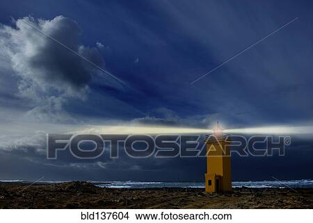 Lighthouse shining over rocky landscape View Large Photo Image Picture - Lighthouse shining over rocky landscape. Fotosearch
