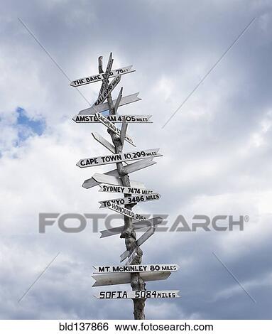 Low angle view of sign post against cloudy sky View Large Photo Image Stock Photograph - Low angle view of sign post against cloudy sky. Fotosearch