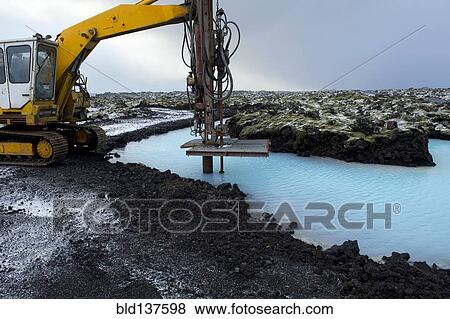 Stock Photo - Machinery drilling into lake in arctic landscape. Fotosearch