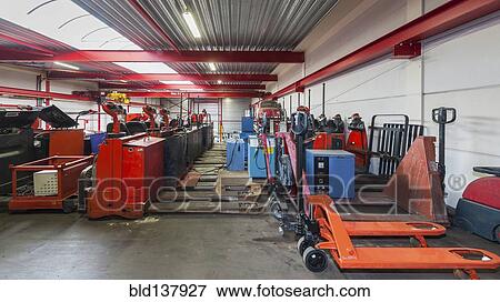 Stock Photo - Machinery parked in warehouse. Fotosearch