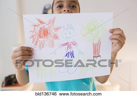 Mixed race boy displaying drawing View Large Photo Image Stock Photograph - Mixed race boy displaying drawing. Fotosearch