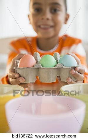 Mixed race boy dyeing Easter eggs View Large Photo Image Stock Image - Mixed race boy dyeing Easter eggs. Fotosearch