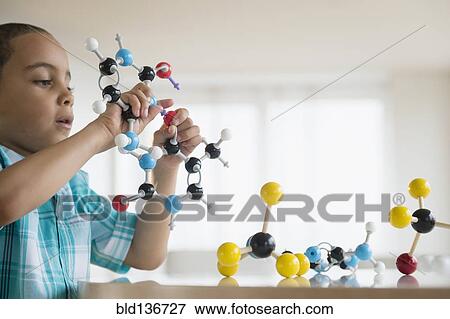 Stock Photo - Mixed race boy playing with molecular models. Fotosearch