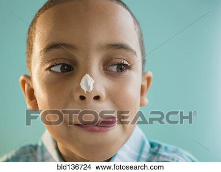 Mixed race boy with icing on nose View Large Photo Image Picture - Mixed race boy with icing on nose. Fotosearch