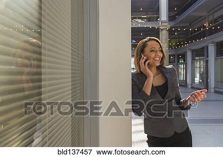 Mixed race businesswoman talking on cell phone View Large Photo Image Stock Photo - Mixed race businesswoman talking on cell phone. Fotosearch