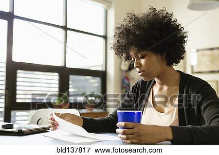 Stock Photo - Mixed race businesswoman working in office. Fotosearch
