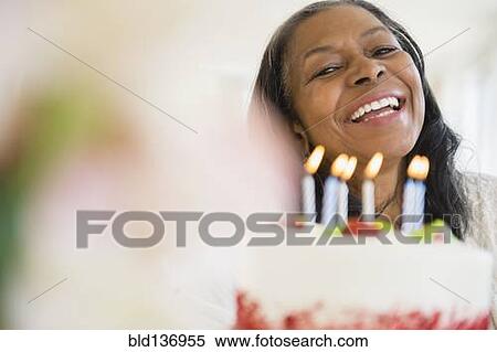 Mixed race woman celebrating birthday View Large Photo Image Stock Photography - Mixed race woman celebrating birthday. Fotosearch