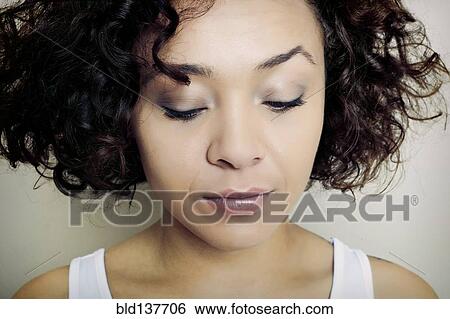 Stock Photograph - Mixed race woman frowning. Fotosearch