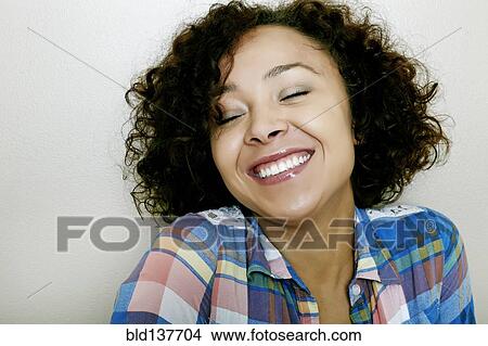 Picture - Mixed race woman smiling. Fotosearch
