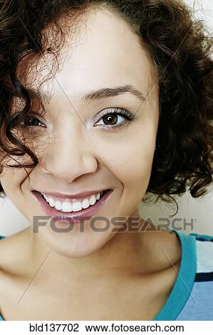 Stock Image - Mixed race woman smiling. Fotosearch