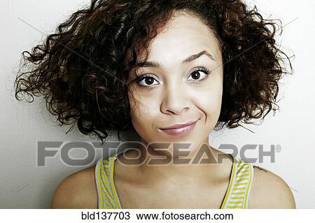 Stock Image - Mixed race woman smirking. Fotosearch