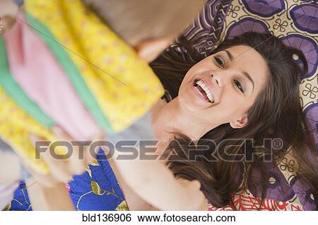 Stock Photograph - Mother and child playing on rug. Fotosearch