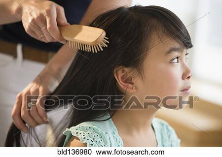 Mother brushing daughter's hair View Large Photo Image Stock Image - Mother brushing daughter's hair. Fotosearch