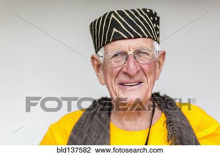 Stock Image - Older Caucasian man wearing striped hat. Fotosearch