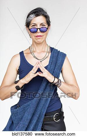 Stock Image - Older Hispanic woman with hands clasped. Fotosearch