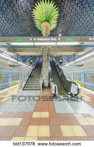 Stock Photo - Ornate pillars, escalator and movie reels on ceiling in subway station, Los Angeles, California, United States. Fotosearch