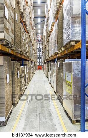 Picture - Packed pallets on shelves in warehouse. Fotosearch