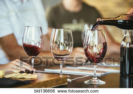 People drinking wine together in bar View Large Photo Image Stock Photograph - People drinking wine together in bar. Fotosearch