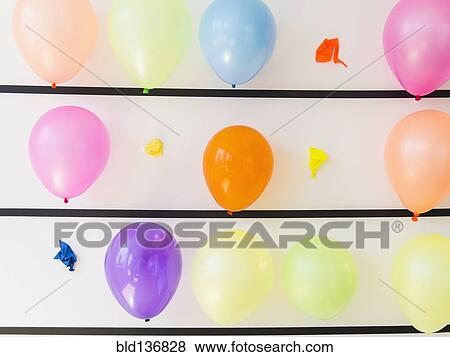 Stock Photo - Popped balloons on wall. Fotosearch