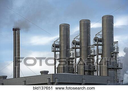 Stock Image - Power plant smoke stacks. Fotosearch