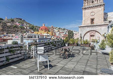 Stock Image - Rooftop cafe with cityscape view, Guanajuato, Guanajuato, Mexico. Fotosearch