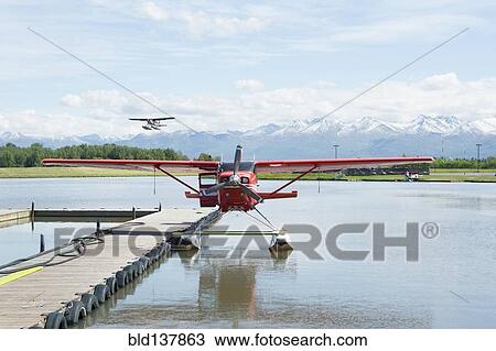 Seaplane docked in rural river View Large Photo Image Stock Image - Seaplane docked in rural river. Fotosearch
