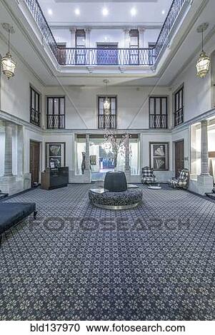 Stock Image - Seating and carpet in ornate hotel lobby. Fotosearch
