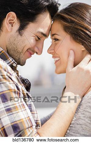 Stock Image - Smiling couple hugging. Fotosearch