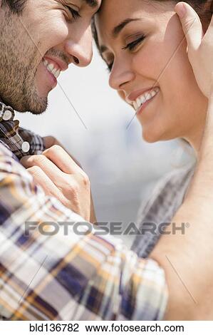 Stock Image - Smiling couple hugging. Fotosearch
