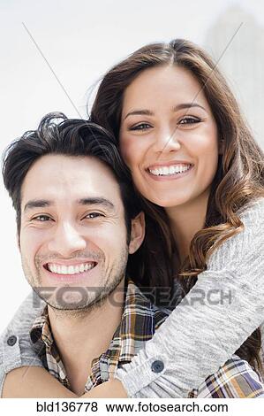 Stock Photo - Smiling couple hugging. Fotosearch