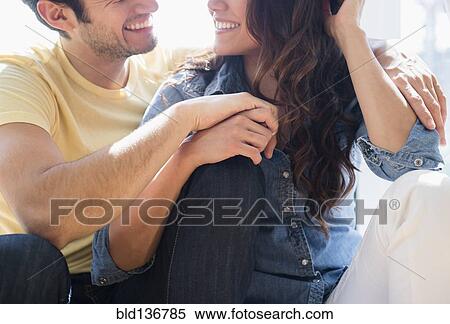 Smiling couple relaxing together View Large Photo Image Stock Photography - Smiling couple relaxing together. Fotosearch