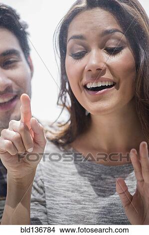 Picture - Smiling couple window shopping together. Fotosearch