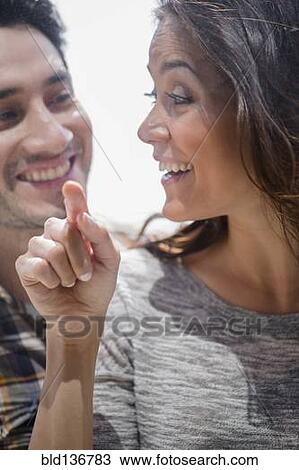 Stock Image - Smiling couple window shopping together. Fotosearch