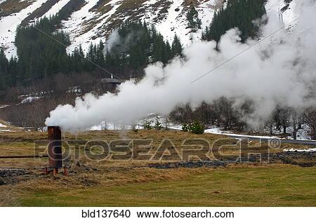 Stock Image - Smoke billowing from column in rural landscape. Fotosearch