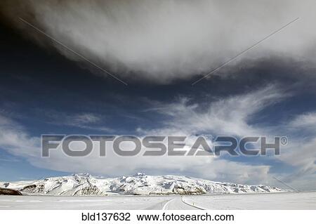 Stock Image - Snow covered mountain in rural landscape. Fotosearch
