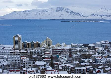 Stock Image - Snowy city and lake in arctic landscape, Reykjavik, Hofudborgarsvaedi, Iceland. Fotosearch