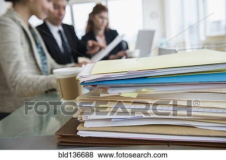 Stock Photo - Stack of papers on desk in office. Fotosearch