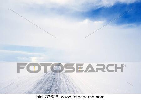 Stock Photo - Tire tracks on rural road in snowy landscape. Fotosearch