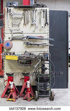Stock Photo - Tools hanging from peg wall in warehouse. Fotosearch