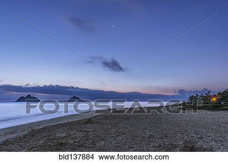 Picture - Waves washing up on tropical beach at twilight, Kailua, Hawaii, United States. Fotosearch
