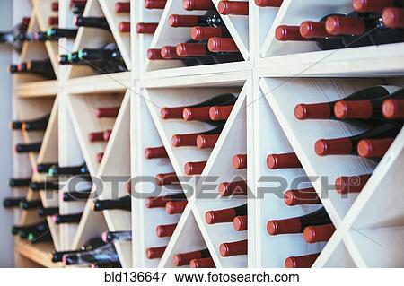 Stock Photo - Wine bottles in rack on wall. Fotosearch