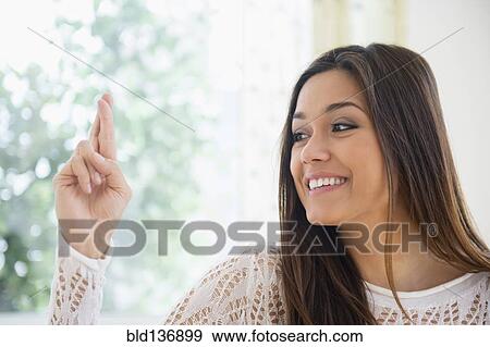Stock Photo - Woman crossing her fingers. Fotosearch