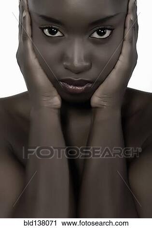 Stock Image - Woman holding her face. Fotosearch