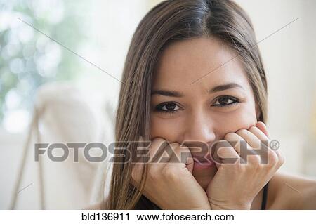 Stock Image - Woman resting chin in hands. Fotosearch
